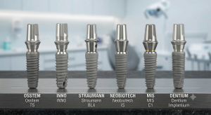 Six dental implant abutments in a row on a lab bench labeled with brands (OSSTEM, INNO, STRAUMANN, NEOBIOTECH, MIS, DENTIUM).